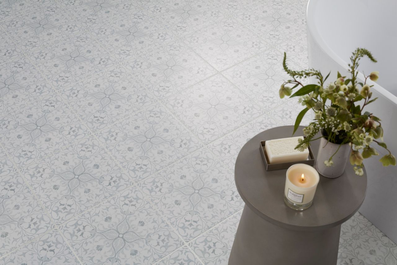 This floor features square porcelain floor tiles with a delicate floral pattern in complementary shade.