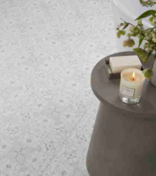 This floor features square porcelain floor tiles with a delicate floral pattern in complementary shades of gray and white.