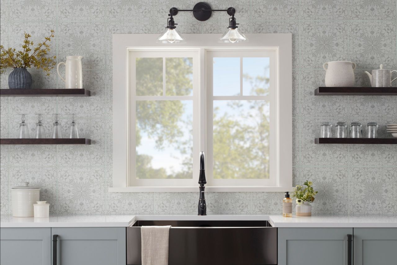 This kitchen features an ornate wallpaper-inspired patterned tile wall.