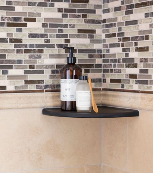 Corner of shower with shelf, brown stone wall tile, and brown and ivory glass mosaic.