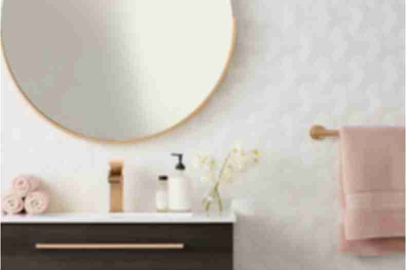 3-D, geometric white wall tile in contemporary and feminine bathroom.