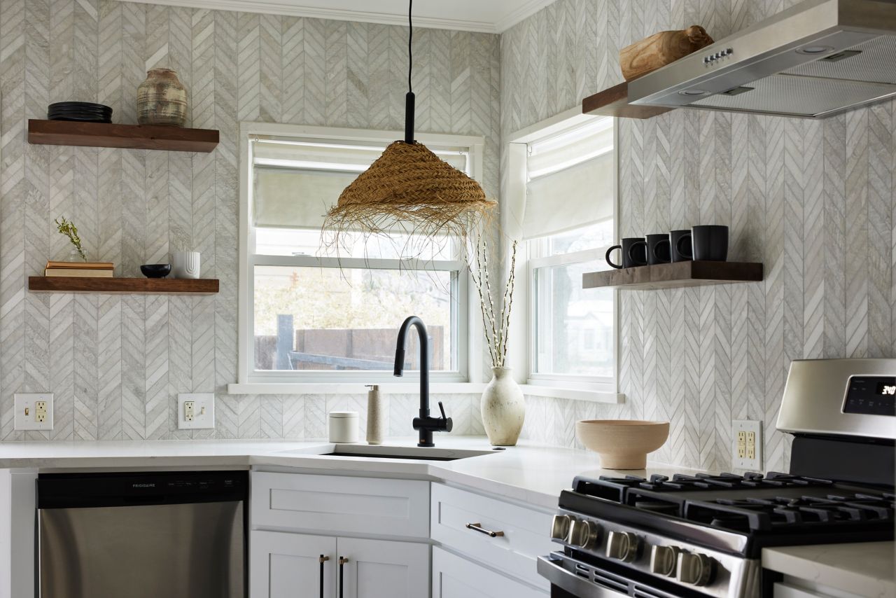 A chic modern kitchen featuring chevron marble mosaic wall tile.