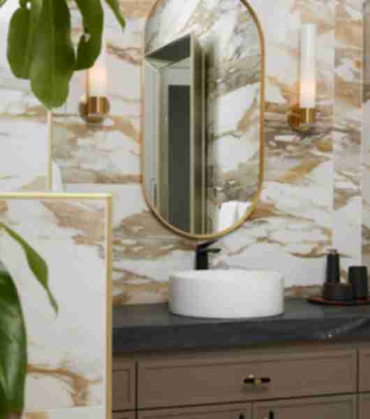 Sink vanity with mirror. White tile with brown veining.