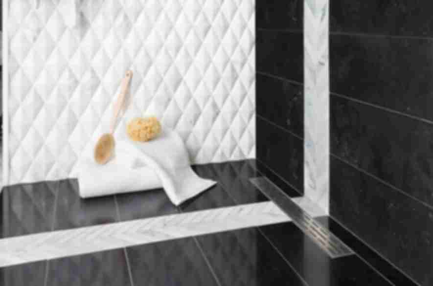 Black and whtie shower with 3-D diamond marble wall tile with black marble wall and floor tile.