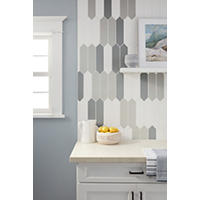 Thumbnail image of Mixed colors of gloss picket tile used as kitchen backsplash ran vertically.  Counter is light beige and cabinets are white with black hardware.