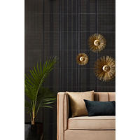 Thumbnail image of Feature wall behind sofa.  Tile is black with gold dotted pieces to make various patterns.