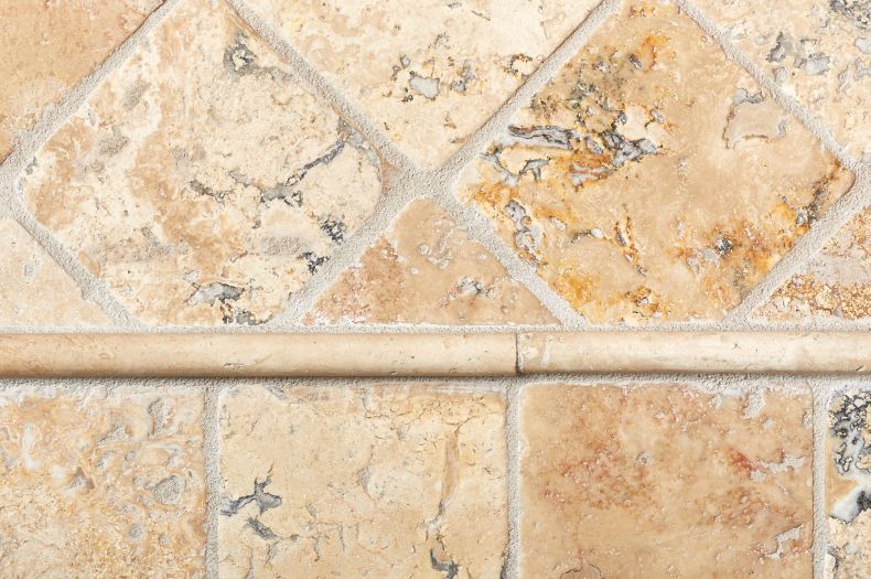 Kitchen backsplash with beige and brown stone wall tile with durand trim.