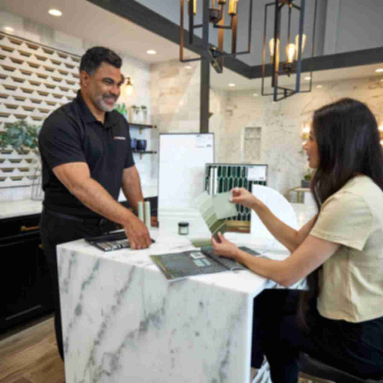 A tile expert provides a design consultation to a customer.