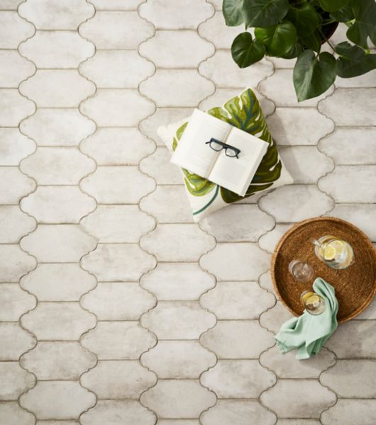 Ivory lantern shaped floor tile in a patio with plants.