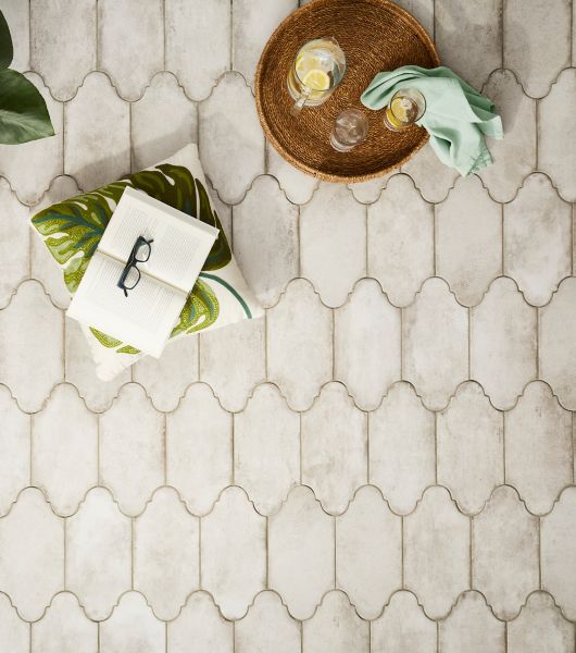 Aerial shot of a grey cement-look porcelain tile patio floor. The tile is a unique oblong shape evoking the air of a Spanish villa.