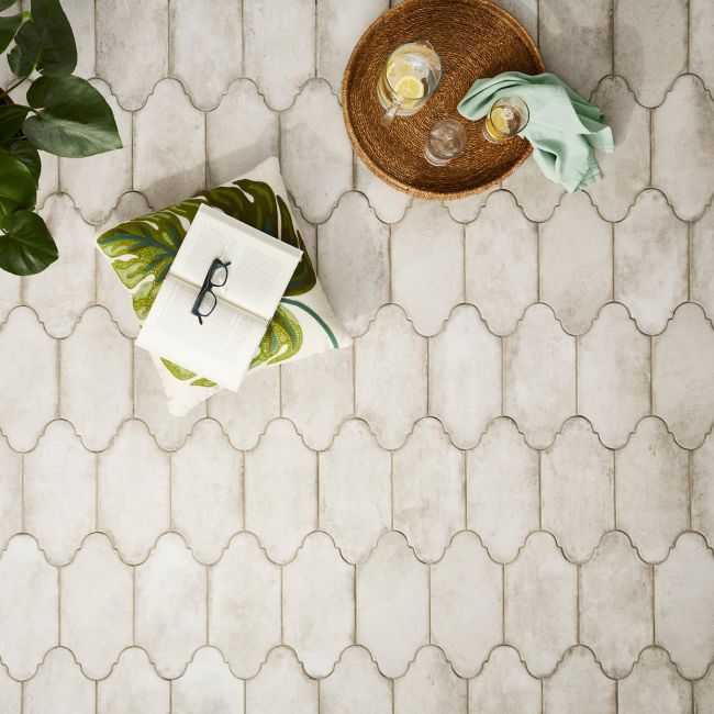 Aerial shot of a grey cement-look porcelain tile patio floor. The tile is a unique oblong shape evoking the air of a Spanish villa.