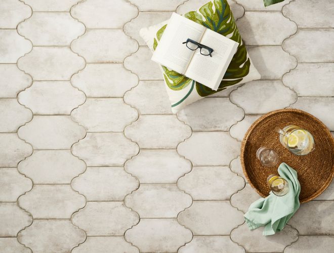 Ivory lantern shaped floor tile in a patio with plants.