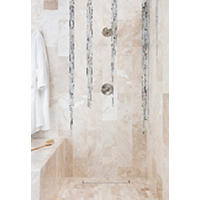 Thumbnail image of Walk in shower in bathroom tiled in natural marble and glass mosaic.  Marble is warn tones of beige and creamy whites.  Floating wood vanity with metal framed mirror.