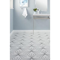 Thumbnail image of Bathroom display with Hexagonal tile white with black lines for pattern.  Modern porcilain sink on metal vanity stand. White baseboard.