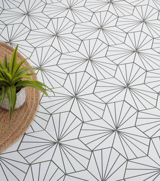 Hexagonal porcelain tile on bathroom floor.  Tile is white with black lines to make a design.