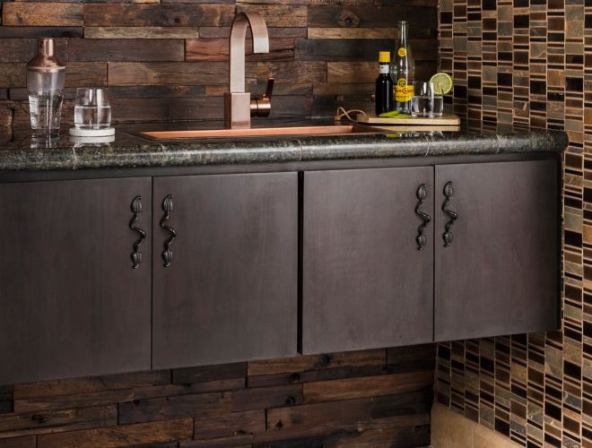 Dark brown reclaimed wood wall tile with dark brown mosaic above bar area.