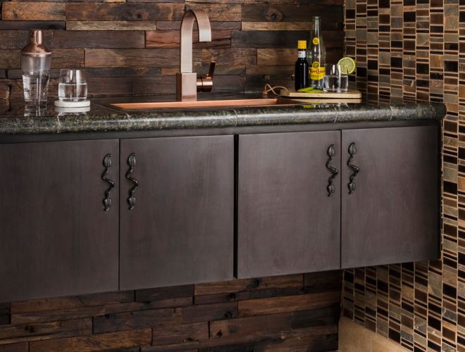 Dark brown reclaimed wood wall tile with dark brown mosaic above bar area.