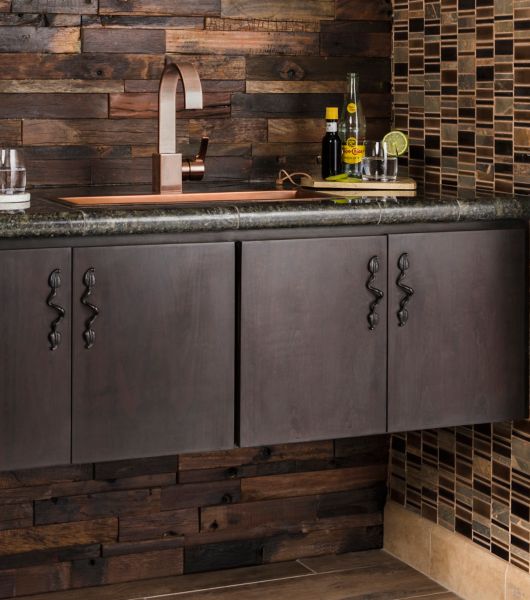 Dark brown reclaimed wood wall tile with mosaic in rustic bar area.