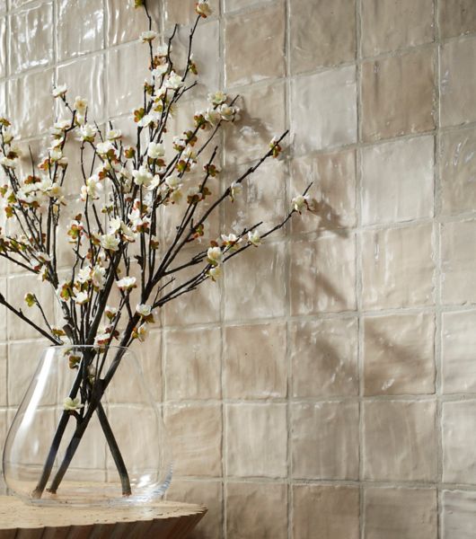 Wall tiled with Riad sand handmade-look ceramic tile, which features variations in color as well as surface texture.