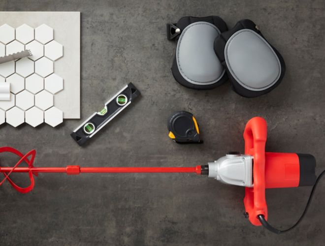 Trowel, measuring tape, mixer and other tile installation tools.