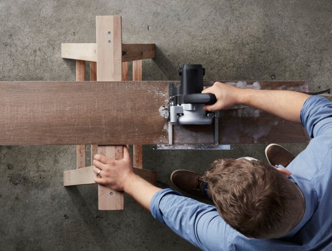 Man cutting tile with a wet saw.