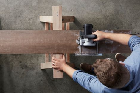 Man cutting tile with a wet saw.
