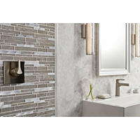 Thumbnail image of Bathroom area with soaker tub and walk in shower.  All areas are tiled in natural nutral toned moarble.  Shower has a focal frame of textured glass and metal mosaic.