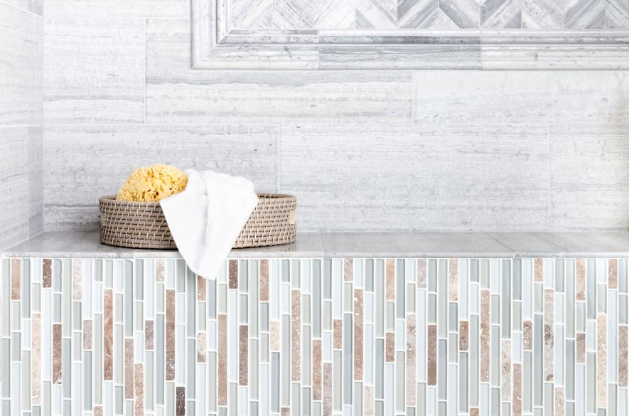 Marble and mosaic wall with a small basket on a shelf.