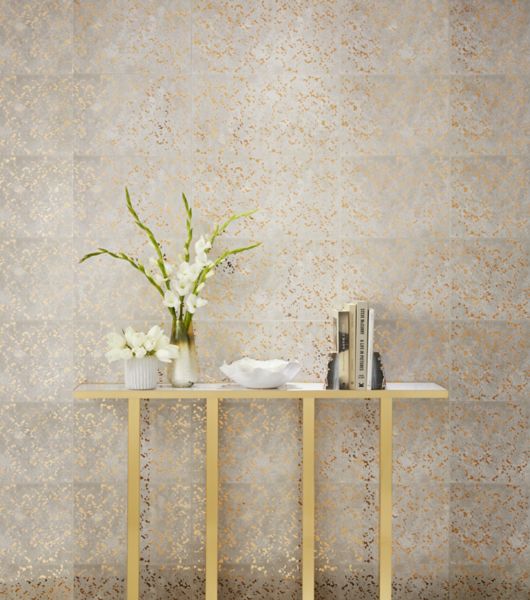 With the combination of metallic, mirrored gold splatters and a cowhide-look texture beneath, Goldleaf Speckle wall tile commands attention from behind the console table in this entryway.