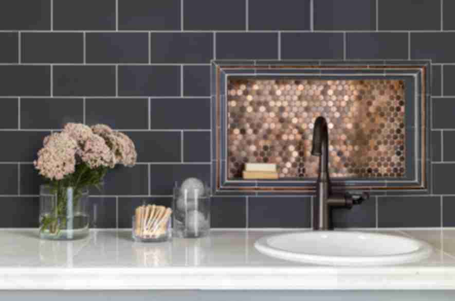 Laundry room backsplash with blue subway tile and metallic copper penny round mosaic.