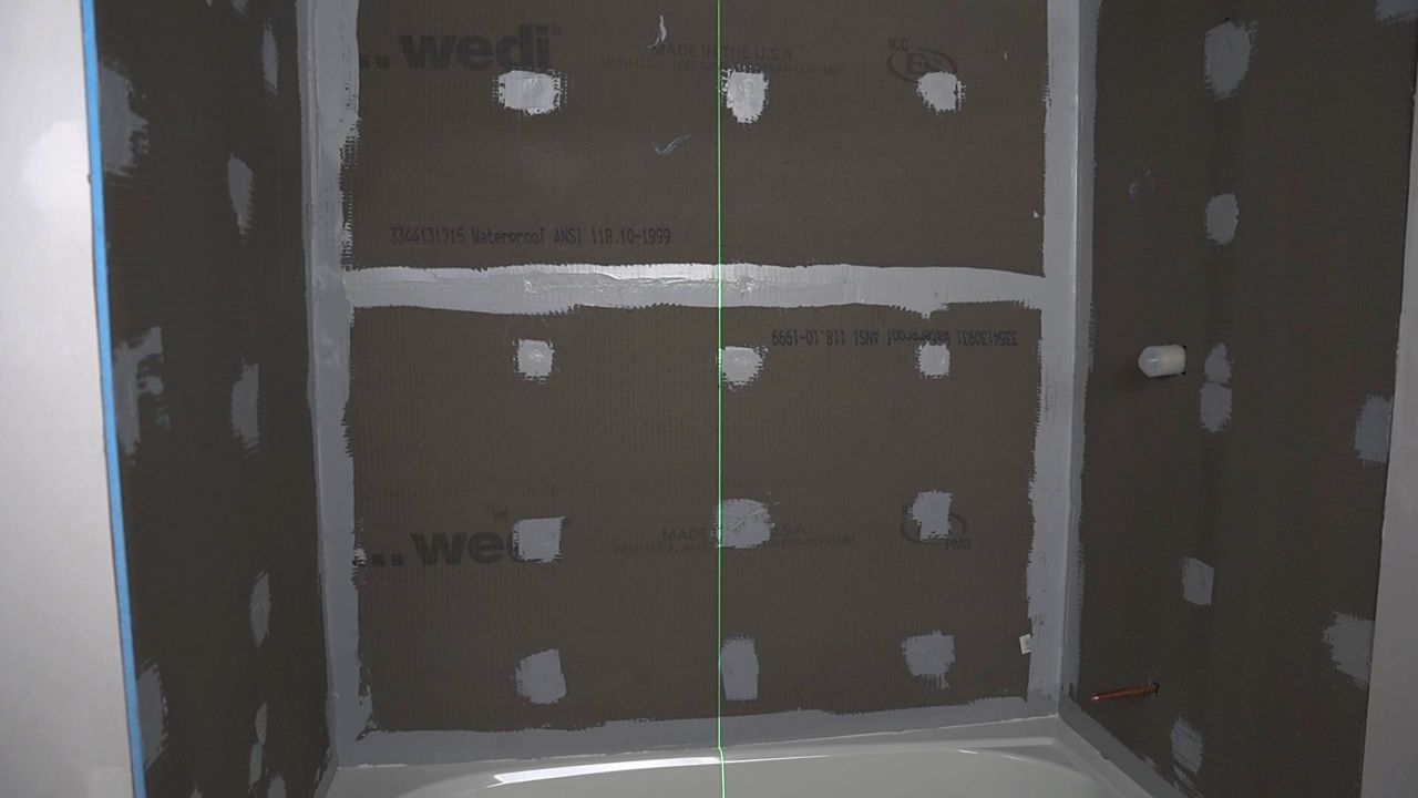 Image showing the center line of a shower wall, which is used to plan the placement of the first rows of tile.