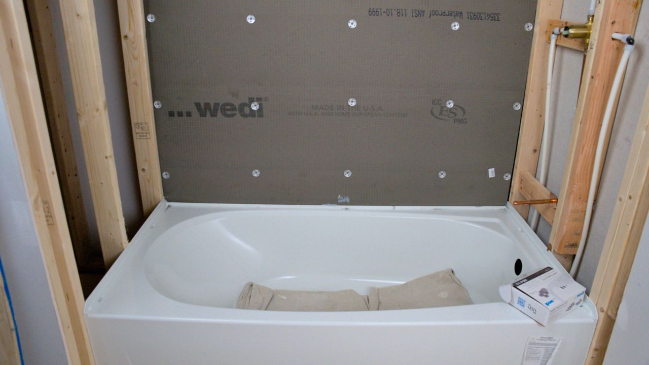 Use the approved screws and washers, 12” apart, to secure backerboard to shower wall studs.