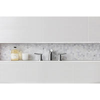 Thumbnail image of  Boasting a hexagon design, the regal, yet contemporary look of this mosaic tile in a clean polished white illuminates even the smallest spaces. This Bathroom has large recessed shelf featuring just that and a slightly textured ceramic field tile.