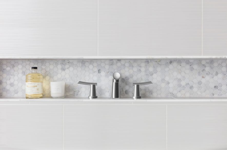 white hexagon tiles and grey cement look tiles in bathroom area.