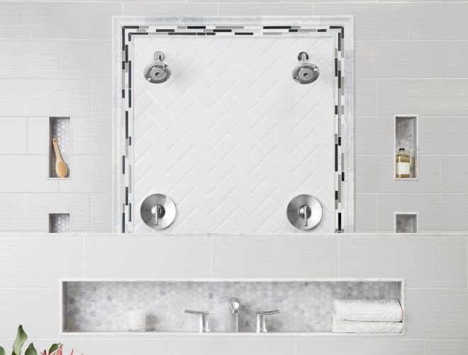 Bathroom with grey and white tile of mixed materials with freestanding tub.