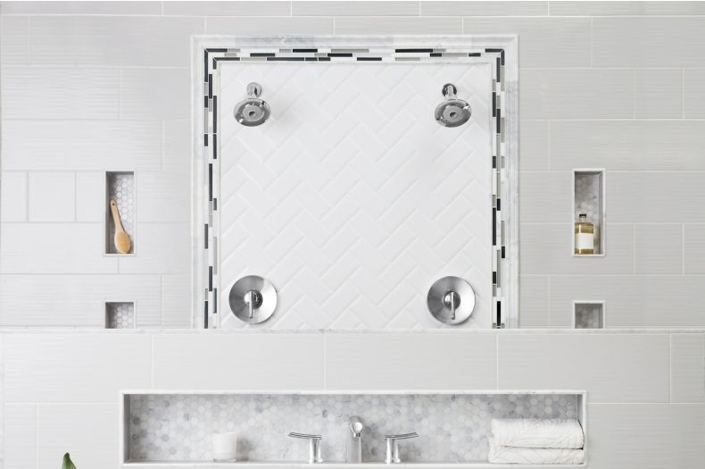 Bathroom with grey and white tile of mixed materials with freestanding tub.