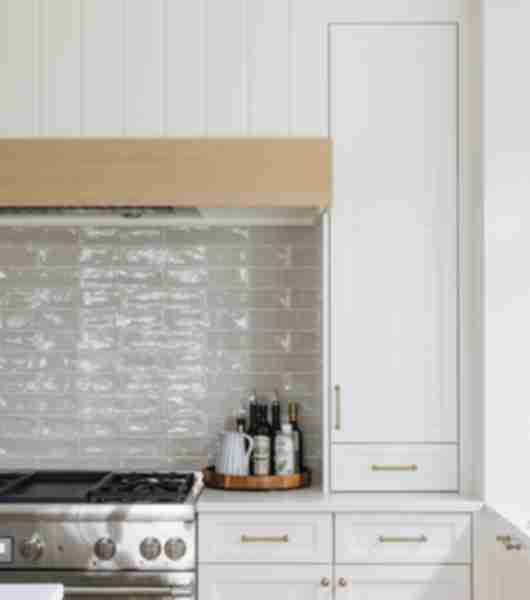 White tile kitchen backsplash with oven and white cabinets