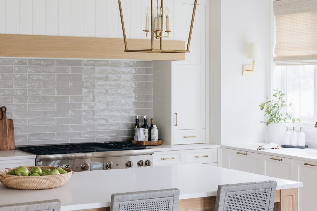 White kitchen with grey subway tile backsplash.