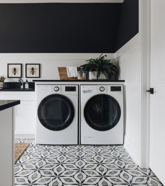 This laundry room features a geometric floral patterned tile floor.