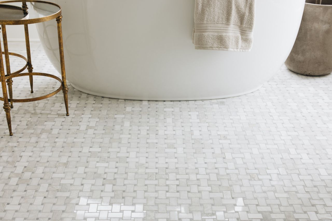 This bathroom floor features white and grey Niles patterned tile mosaic.  class=