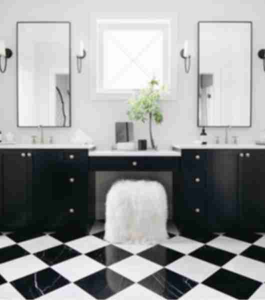 Black and white marble checkerboard tile floor with double sink vanity.