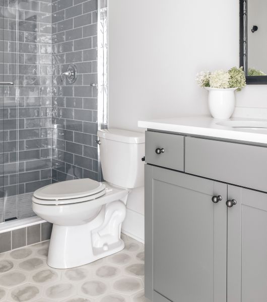 Bathroom with grey tile shower and hexagon tile floor