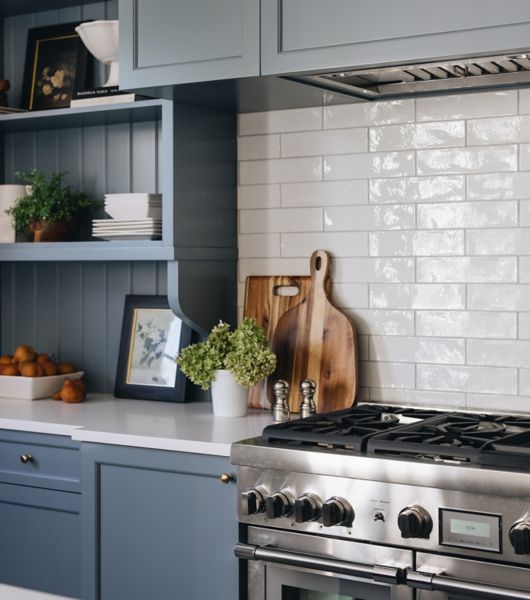 Kitchen backsplash with white brick-laid Retro Lino ceramic subway tile above the stove.