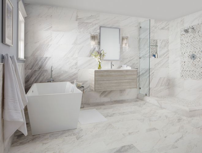 bathromm with natural marble on floor and walls and shower