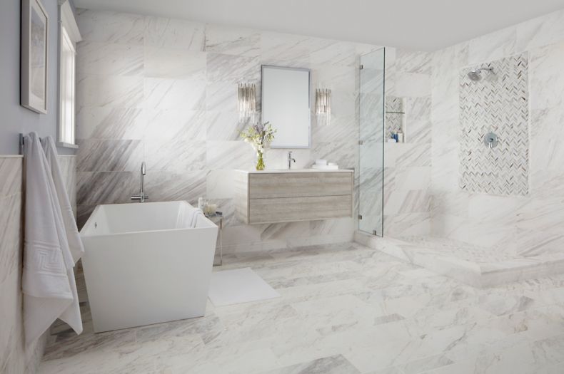 bathromm with natural marble on floor and walls and shower