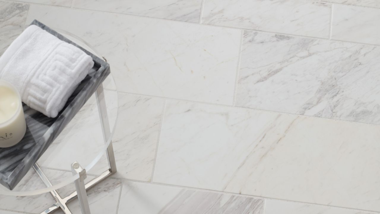 Aerial shot of a white marble subway tile floor with a small table.
