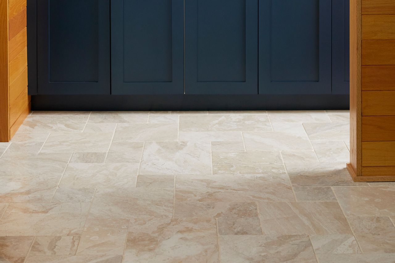 A kitchen with beige Versailles patterned tile floor.