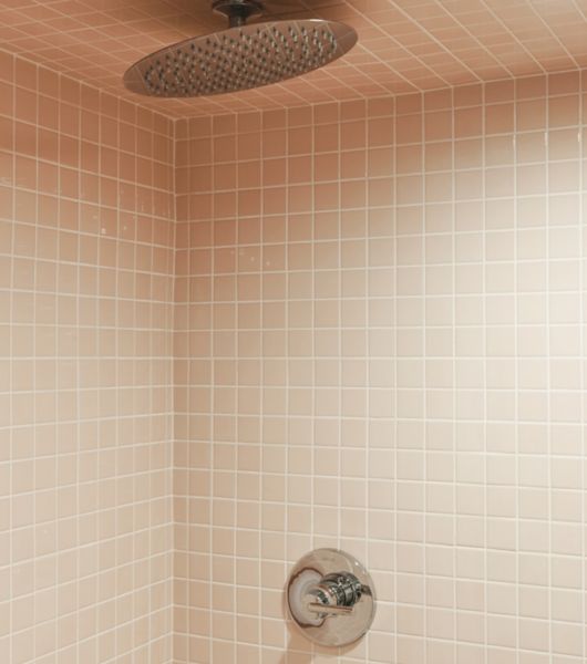 This bathroom features small square peach-colored tile.