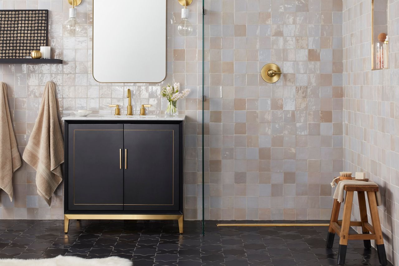 Bathroom with square handmade tile in varying shades of white, grey and cream.