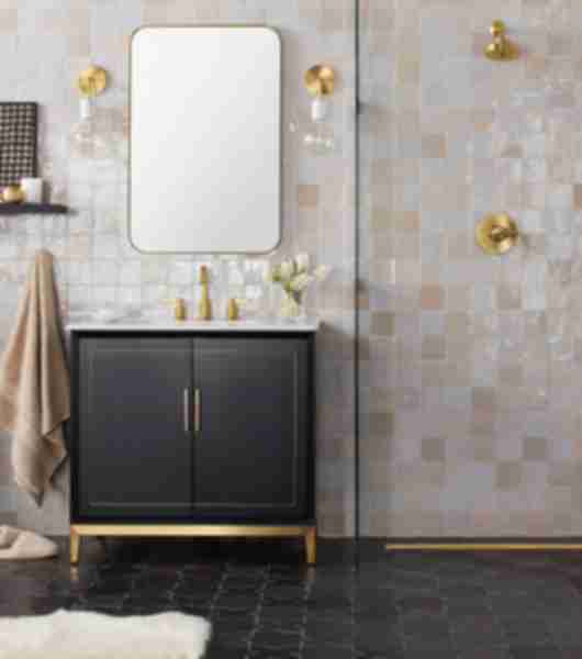 Bathroom shower and sink vanity with wall tiled in cream-colored tile